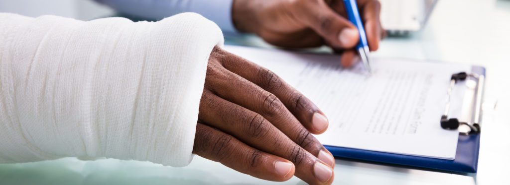 Blog Injured Man Filling Insurance Claim Form